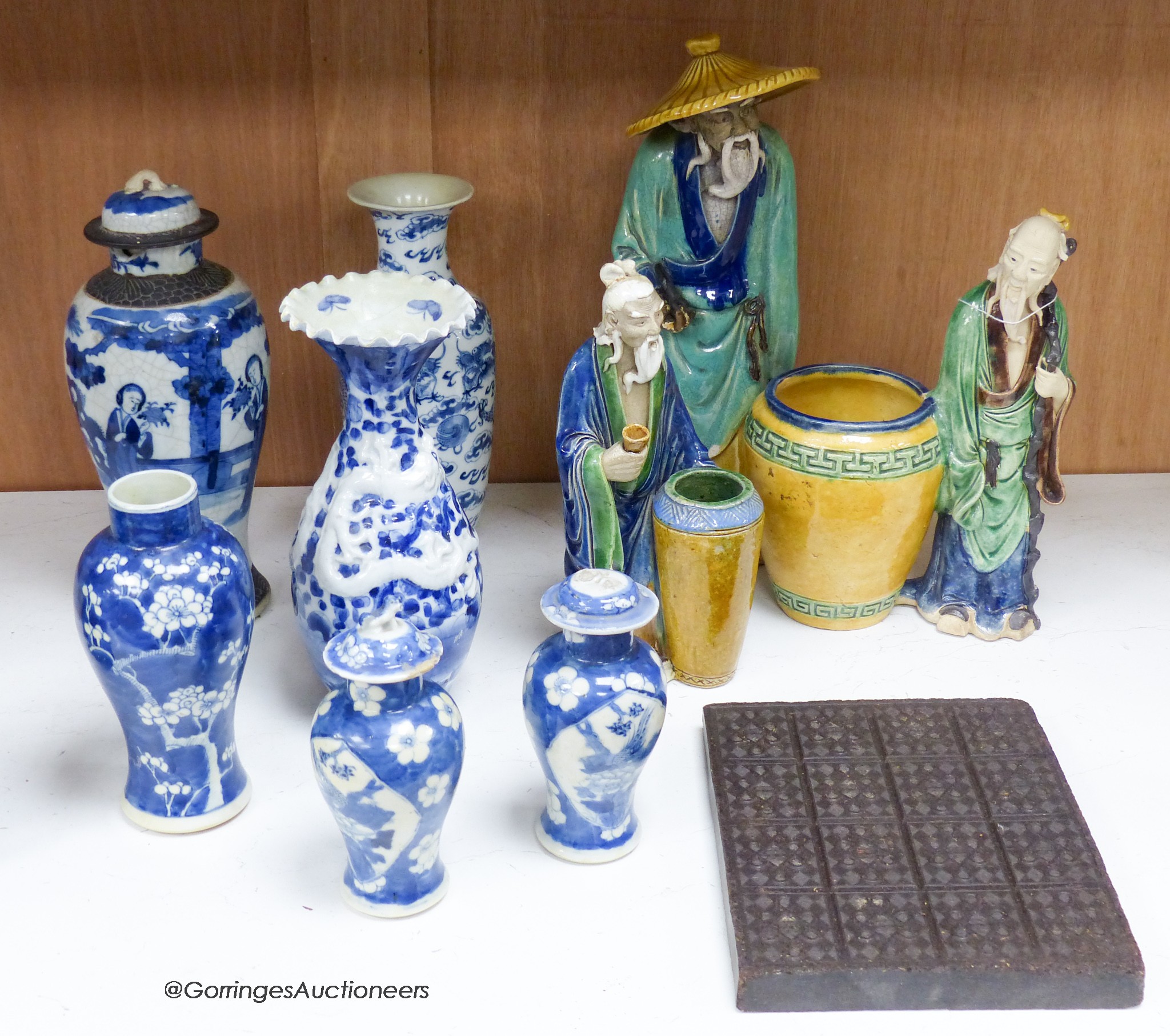 A collection of Chinese vases pottery figures and a compressed tea block, tallest piece 35cm